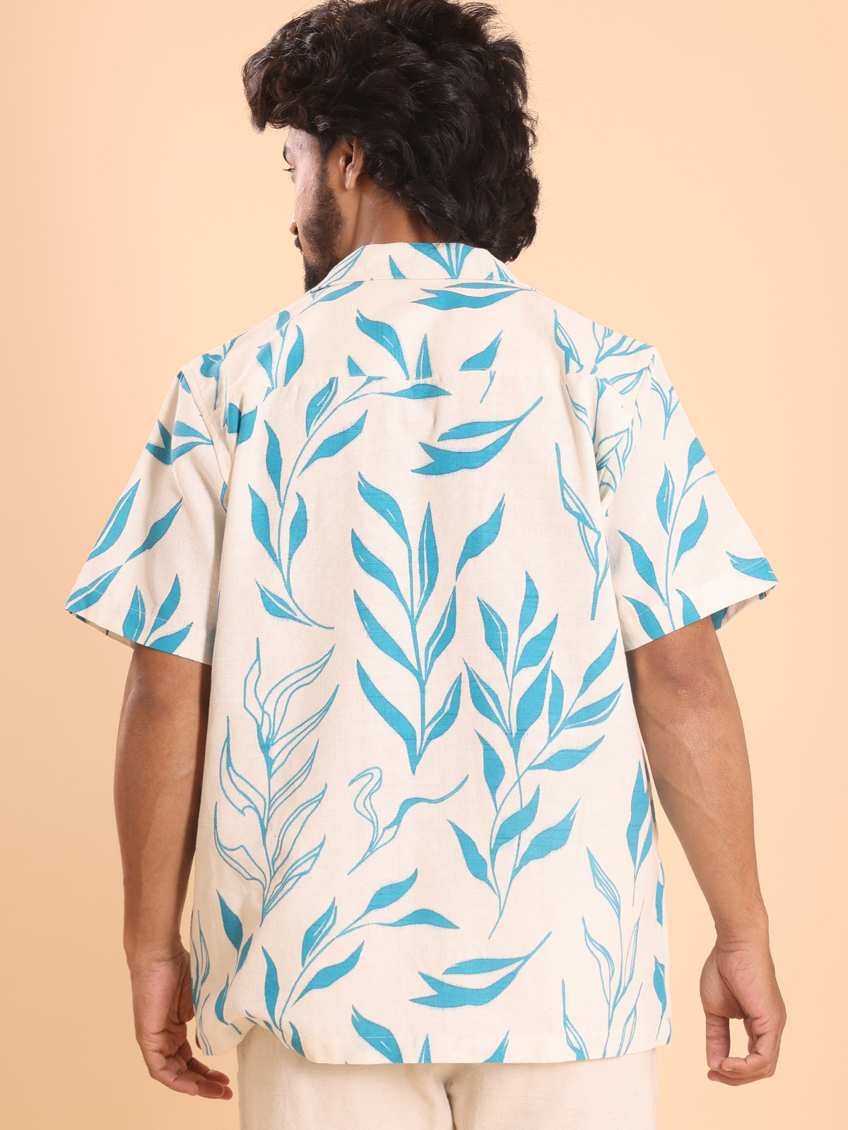 Back view of men's handspun cotton shirt with leaf print